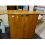 1960's teak metamorphic bar, 2 cupboards to the front opening to reveal a fitted bar type interior