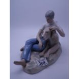 Lladro style group of a young boy and a Great Dane, marked to the base made in Spain 10" long