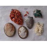 Two cameo brooches, a coral brooch etc