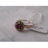 A circular ruby & diamond gold mounted cluster ring approx size 'M'