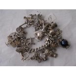 A good heavy silver charm bracelet set with multiple charms 95g
