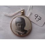 An antique double sided glass 9ct locket