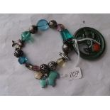 A metal & glass bead bracelet and an Art Deco stone set brooch