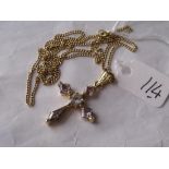 A gold mounted gem set cross on 9ct chain