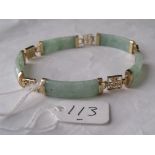 A green stone bracelet with 9ct mounts