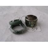 Two green stone band rings and an abalone set band ring
