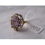 An amethyst dress ring in fancy gold mount size R