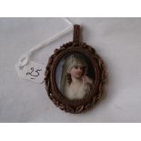 A good painted miniature in a carved mount 5cm long