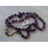 An antique Amethyst and gold bead necklace with carved amethyst Sphinx to centre and gold clasp 38g