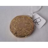 An antique round gold engraved locket