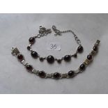 A nine stone garnet cabochon silver mounted necklace also a similar bracelet 32g inc