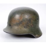 1939-1945 German M42 field-camoflaged helmet. With liner and chin-strap (broken), the liner