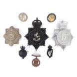 Irish Police and Prison Service badges. A Garda Síothchána helmet plate, a Royal Irish
