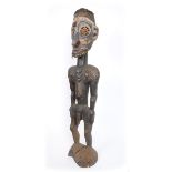 Papua New Guinea Tribal ancestral figure. A carved wood male figure the face decorated with