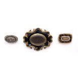 19th century mourning brooches. A Victorian gilt metal and French jet hairwork brooch; a late