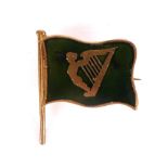 Early 20th Century Nationalist flag pin. A gilt metal and green enamel pin-back badge in the form of
