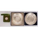 A pair of 20th century Irish silver circular waiters and a medal by Douglas Bennett. A pair of