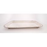 George V silver tray. An early 20th century silver rectangular tray, the raised rim with beaded