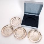 Irish silver waiters. A cased set of four 20th century Irish silver circular waiters, the central