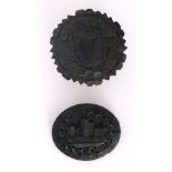 Bog oak ware. A bog oak, oval brooch carved with a view of a castle; together with a bog oak