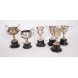 Six silver trophy cups, unengraved. A set of four 1950s silver, two-handled trophy cups, Birmingham,