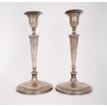 George III table candlesticks. A pair of George III silver table candlesticks, urn-shaped candle-