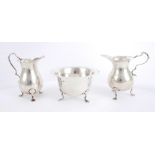 Silver cream jugs and sugar bowl An Edwardian silver baluster-shaped cream jug, by Mappin & Webb,