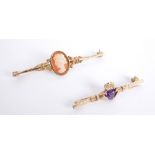 Gold brooches. An amethyst-set 9ct yellow-gold Claddagh brooch and a 9ct yellow-gold cameo