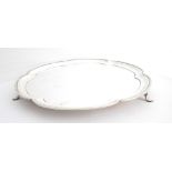 A mid-20th century silver tray. A silver, circular tray, the lobed, moulded rim enclosing a plain,