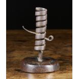 An English 18th Century Iron Spiral Strap Candlestick with revolving height adjuster on a turned