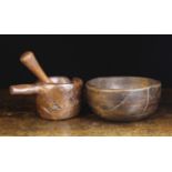 A Rustic Dug-out Mortar & Pestle, and a turned Elm Bowl (A/F).