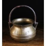 A Small 16th/17th Century Bronze Cauldron with iron swing handle looped through triangular lugs