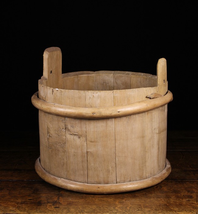 A Wooden Bucket composed of Pine Staves bound in willow withies;