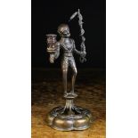 An Antique Bronze Gothic Style Figural Candlestick of dark brown patination.