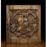 A Small 16th Century Oak Panel carved with a profile of a woman's head in a ring adorned with