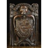 A Fine 16th Century Carved Oak Beam Angel bearing a Heraldic shield,