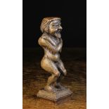 A Small 17th Century Carved Oak Figure of a Naked Grotesque Man stood crouching with his arms