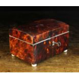 A 19th Century Red Tortoiseshell Veneered Box raised on turned ivory bun feet, 4 ins (10 cms) high,