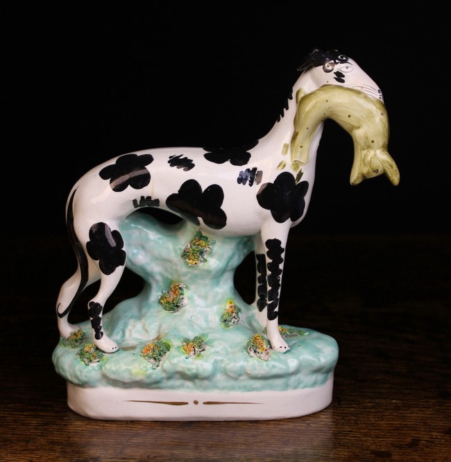 A Victorian Staffordshire 'Disraeli' Greyhound with hare in mouth.