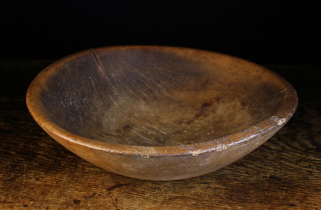 A 19th Century Treen Dairy Bowl, 5½ ins (14 cms) high, 19½ ins (49.5 cms) wide.