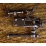 A Small Antique Vice with screw-thread table top clamp, 3½ ins (9 cms) in length.