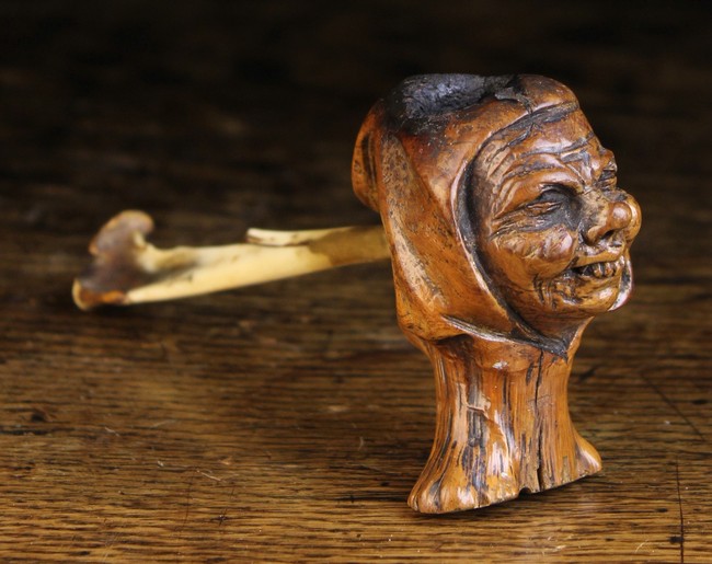 An Unusual 19th Century Pipe with an animal's bone forming the shaft and a carved wooden bowl in