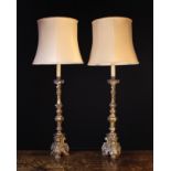 A Pair of 18th Century Carved Giltwood Candlesticks converted to electric lamps.