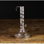 An Early 19th Century Coiled Strap Candlestick with height adjuster on a treen base,