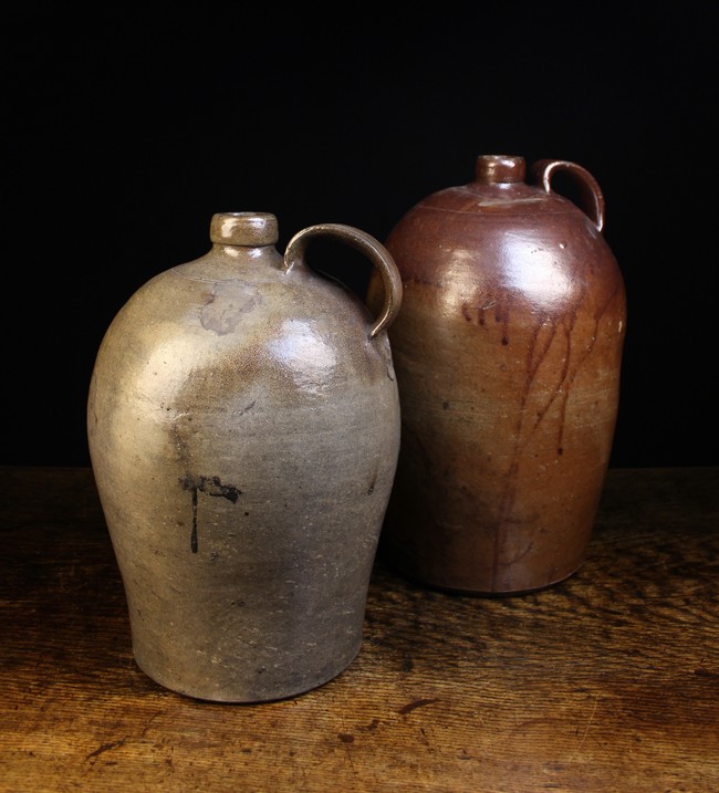 Two Large 19th Century Stoneware Flagons with ring turned shoulders and moulded strap handles;