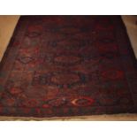 An Antique Soumak Carpet woven with octagonal medallions predominantly in claret,