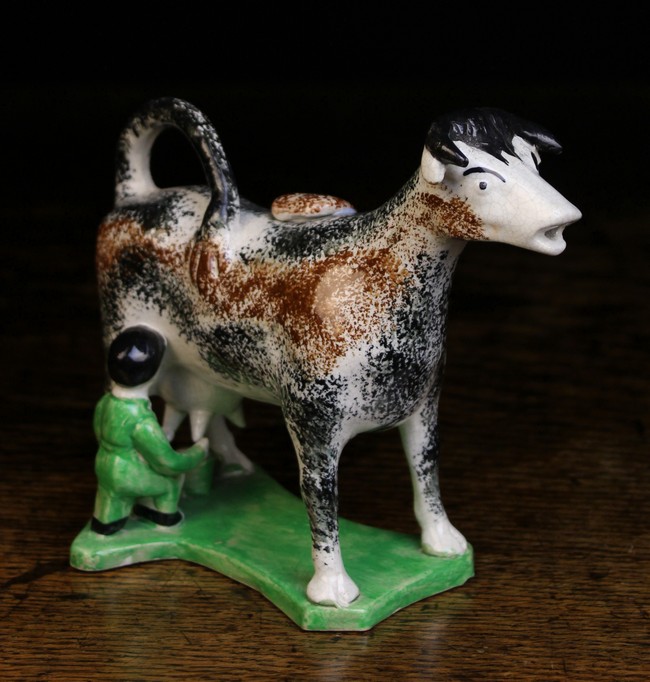 A 19th Century Staffordshire Creamer modelled as a cow with sponged black & brown markings,