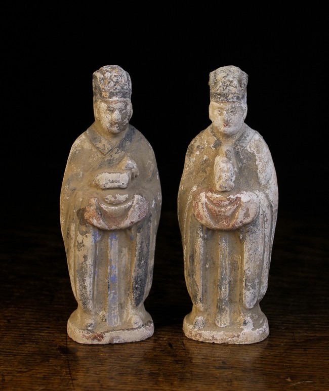 A Pair of Chinese Han Dynasty Pottery Tomb Figures, 7¼ ins (18.5 cms) in height.