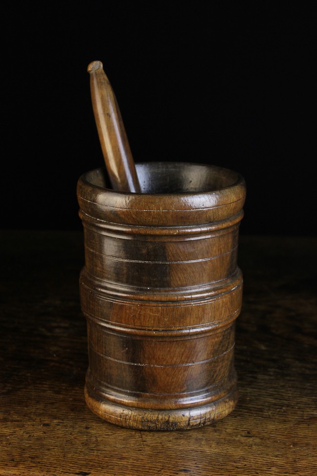 A 17th Century Turned Treen Pestle & Mortar. The mortar 8½ ins (21.5 cms) high, 5¾ ins (14.