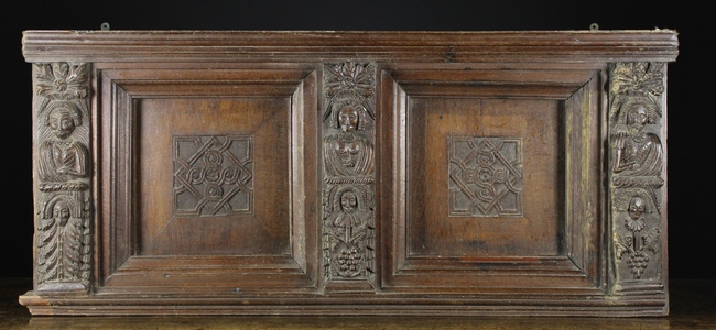 A 17th Century Carved Oak Bed-head Section comprising of two recessed panels centred by squares of